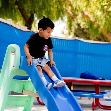 boy going down a slide