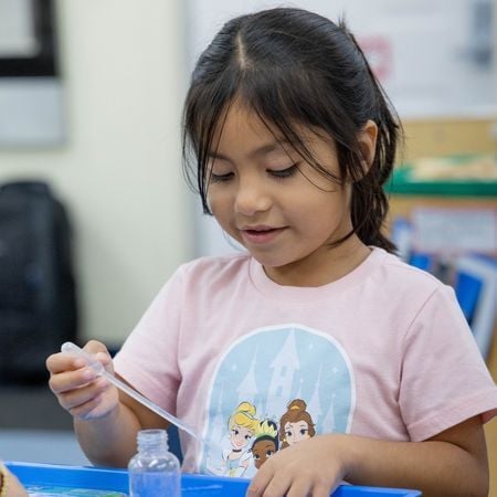 girl using a water dropper for an experiment