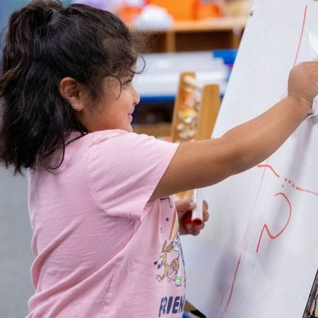 girl drawing on a canvas