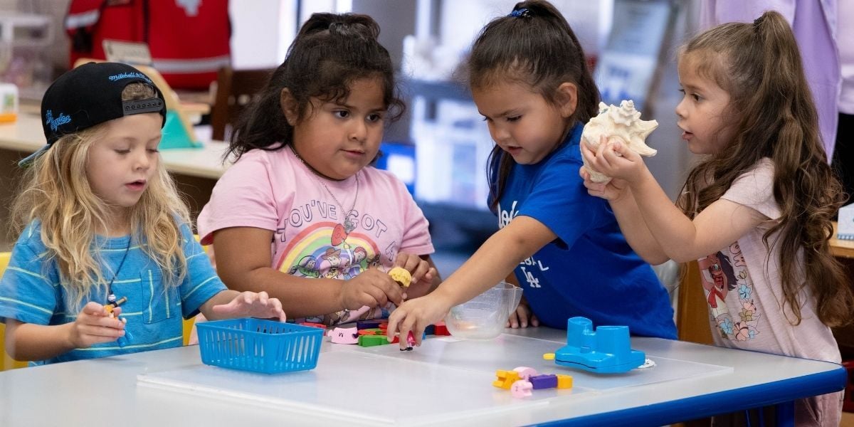 children playing with clay in a classroom
