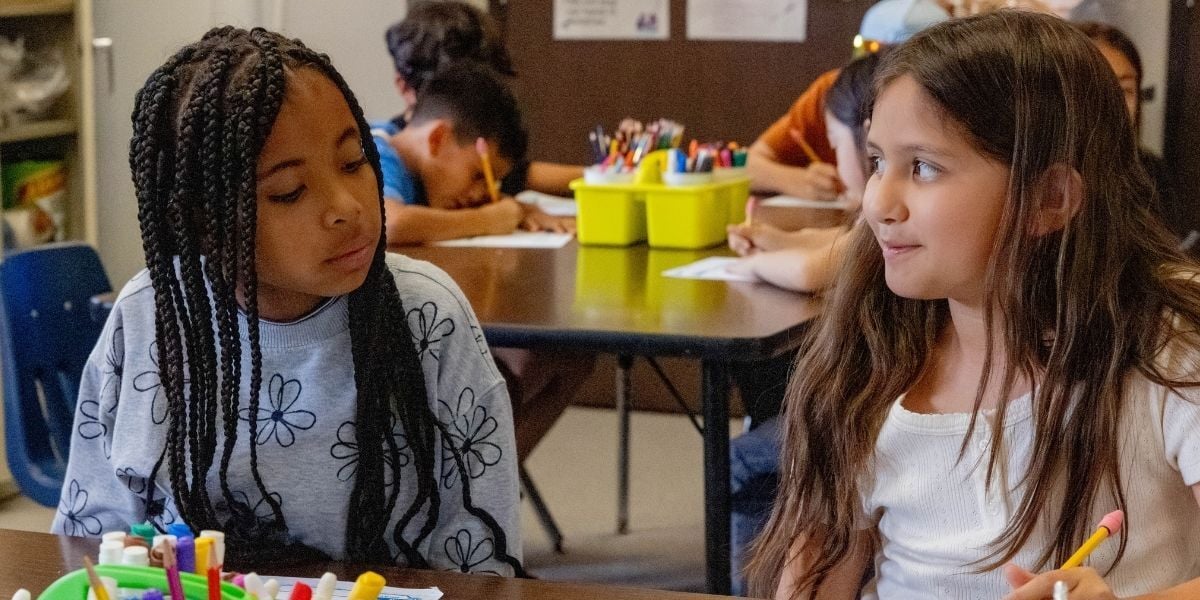 two young girls working on an assignment 