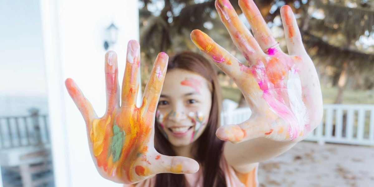 girl with paint on her hands 