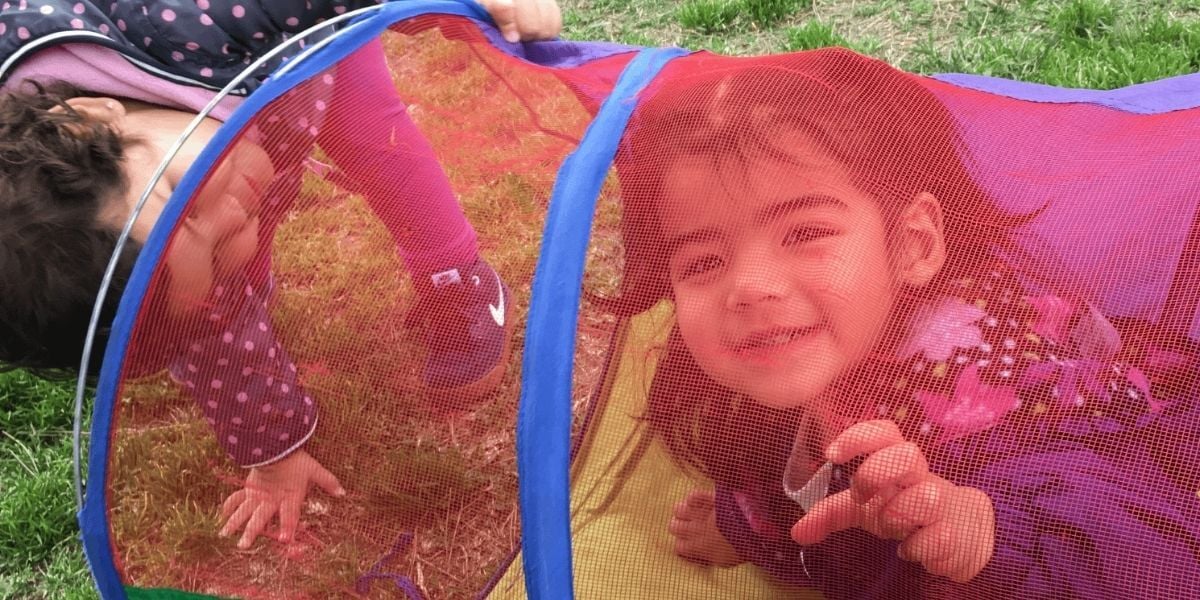 toddler girl in colorful tube