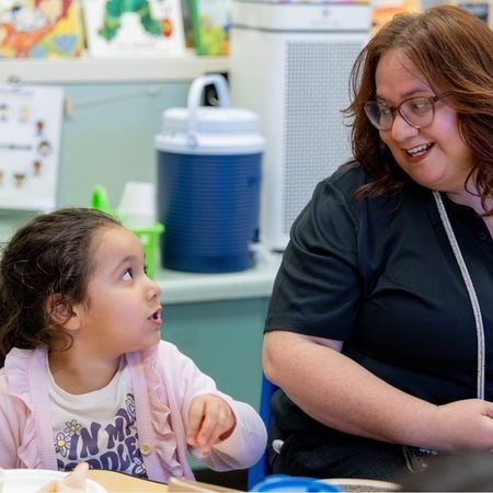 teacher smiling at a female student