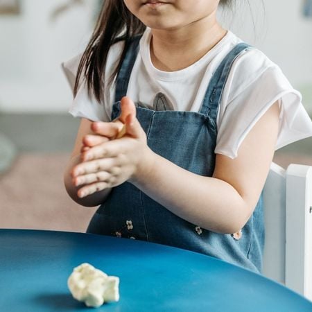 girl playing with clay