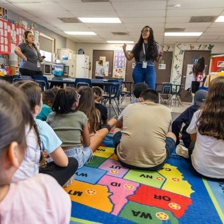 teacher talking to a class of toddlers
