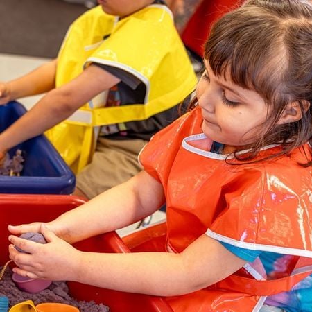 preschool child playing with clay