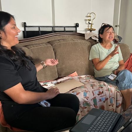 a parent coach sitting next to a parent on the couch