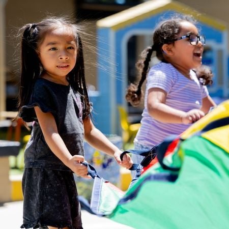 girls playing with a parachute
