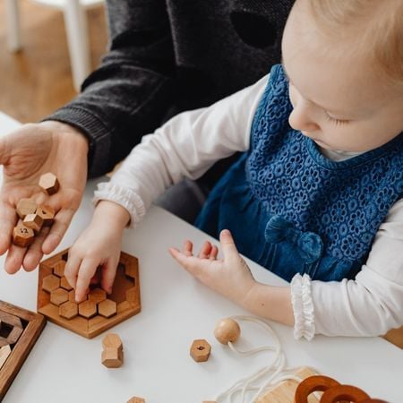a young girl plays a game with blocks