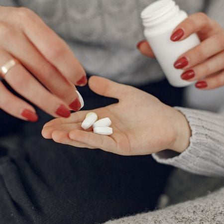 mom handing daughter medication