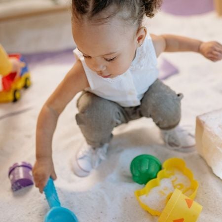 girl playing with a sand box