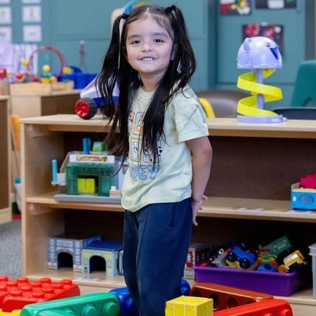 girl playing with giant blocks