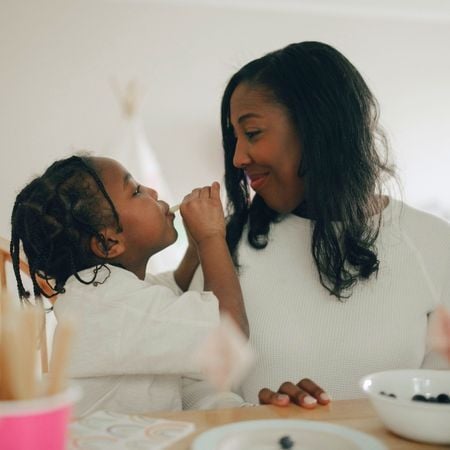 mom and daughter smiling at each other