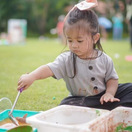 girl playing with a sensory box