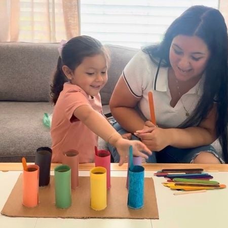 a child and a parent playing the color sorting activity