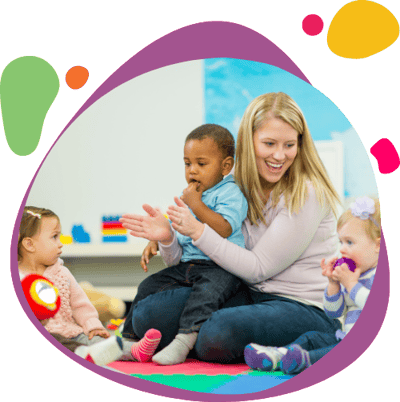 Daycare provider playing with three toddlers