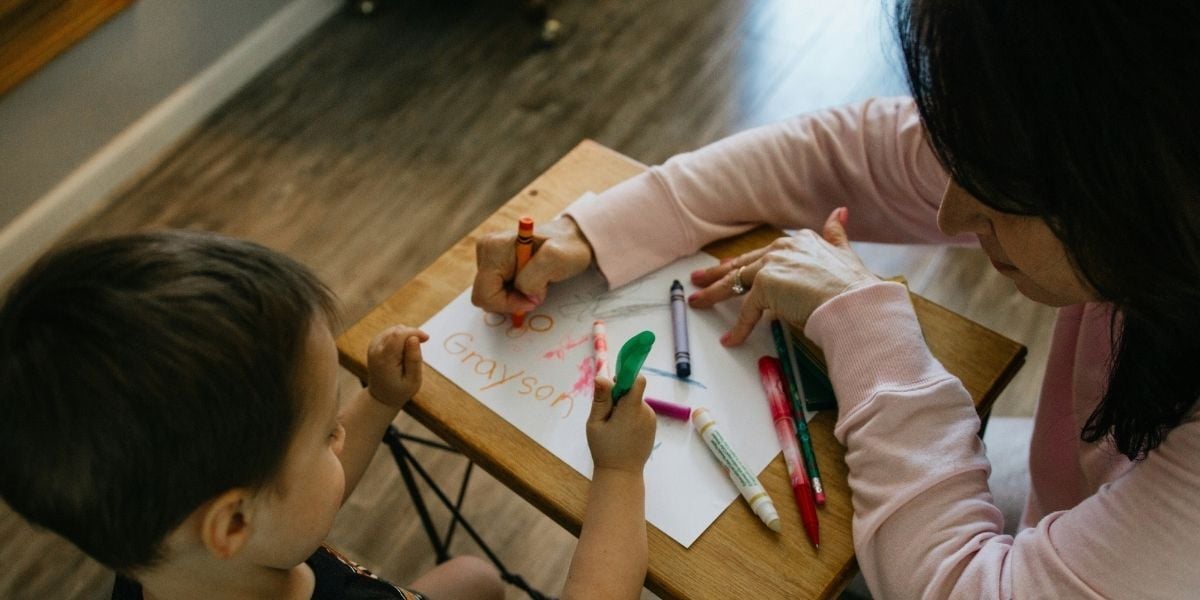 child coloring with a parent